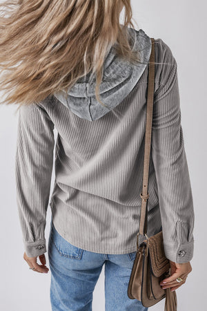 Gray corduroy shirt jacket with contrast hood and button cuffs, worn with jeans.