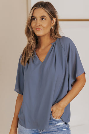 Dusty Blue relaxed V-neck blouse with cap sleeves and gathered neckline detail