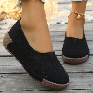 Black floral cutout slip-on loafers with comfortable breathable design.