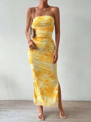 Yellow tie-dye ruched bodycon midi dress with a slit and strapless neckline.