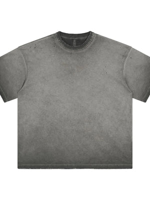 Distressed oversized gray washed effect t-shirt with raw hem and neckline.