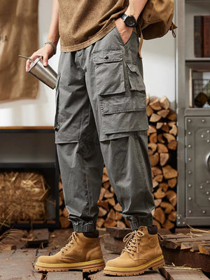 Grey relaxed fit cargo pants with multiple pockets and elastic cuffs.