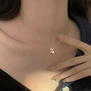 Silver percentage pendant necklace with pearl detail on a delicate chain