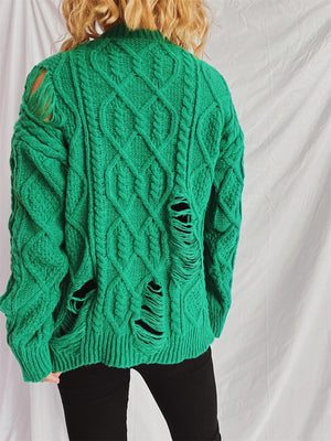 Green distressed cable knit sweater with ripped details.