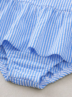 Blue and white striped seersucker one-piece swimsuit with ruffles and a ruffled leg opening.
