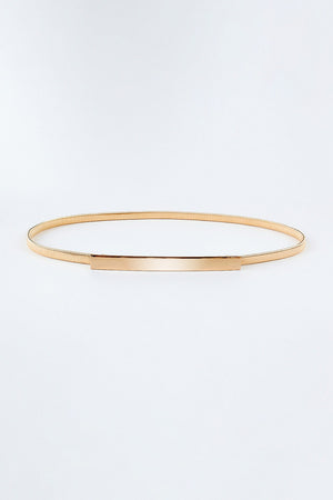 Slimline gold-tone metal waist belt with a polished rectangular buckle.