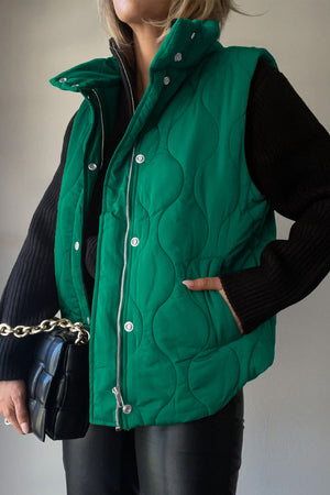 Green quilted stand-collar utility gilet with snap closures and pockets.