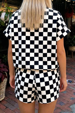 Black and white checkerboard two-piece set with short sleeves and shorts.