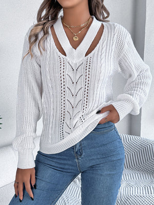 White cable knit sweater with cutout neckline and open knit details.