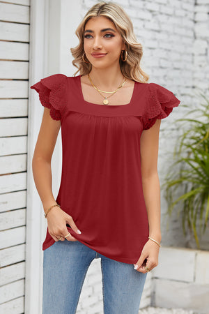 Rust eyelet flutter sleeve square neck blouse with smocked bodice detail.
