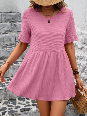 Blush pink textured babydoll blouse with flutter sleeves and a gathered waist.