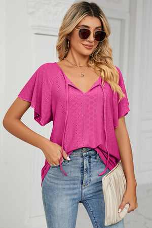 Hot Pink eyelet tie-neck blouse with flutter sleeves and V-neck.