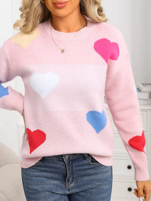 Pink acrylic knit sweater with multicolor heart pattern and round neck.