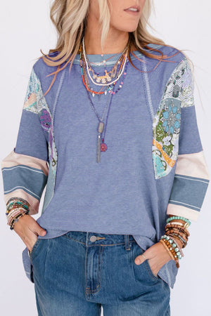 Patchwork stripe raglan sleeve tee in dusty blue with artistic floral panels and contrasting cuffs.