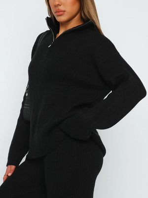 Black ribbed knit quarter-zip lounge set with a relaxed fit and silver zipper detail.