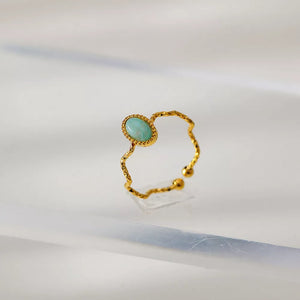 Wavy gold-plated ring with oval blue natural stone, delicate adjustable style.