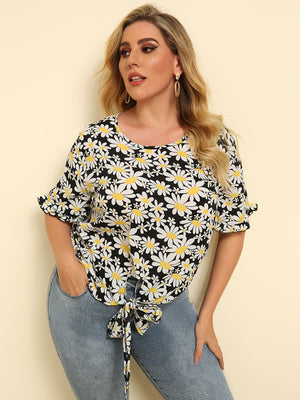 Daisy print knot top with ruffle sleeves and a scoop neckline.