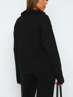 Black ribbed knit quarter-zip loungewear set with a relaxed fit and high collar.