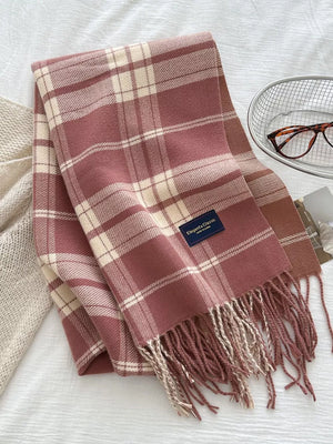 Pink plaid scarf with fringe and cream accents, featuring a classic tartan pattern.