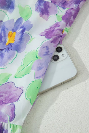 Mini dress with vibrant purple floral print and ruffled hem detail.