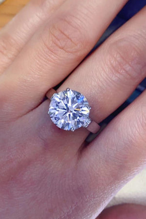 Silver ring with large radiant moissanite solitaire and pavé shoulder details.