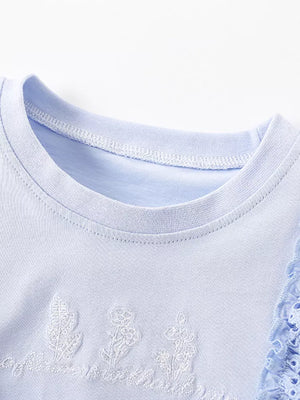 Children's light blue cotton t-shirt with embroidered flowers and ruffled eyelet sleeves.