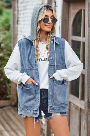Denim hybrid vest with detachable hood in medium wash, buttoned front, and chest pockets.