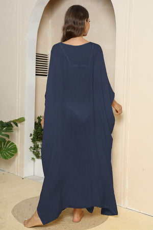 Dark blue oversized caftan cover-up with side slits and wide sleeves.