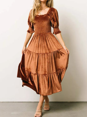 Velvet midi dress in caramel with smocked bodice and ruffled puff sleeves.