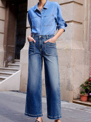Patch pocket wide-leg jeans in medium wash denim with a faded effect.