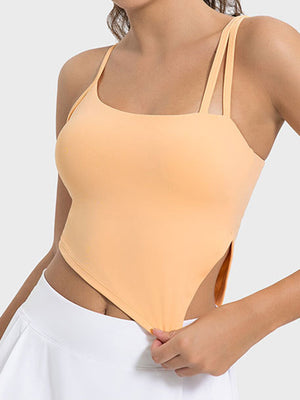 Sherbet asymmetric cutout cami top with double spaghetti straps and side slits.