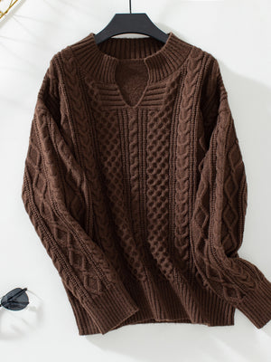 Chocolate cable knit sweater with keyhole neck and ribbed cuffs.