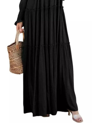 Black smocked v-neck tiered maxi dress with long sleeves and a ruffled hem.
