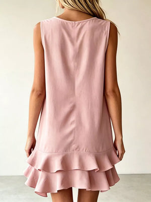 Pink tiered ruffle mini dress with a sleeveless, A-line cut.