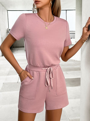 Dusty pink t-shirt romper with drawstring waist and patch pockets.