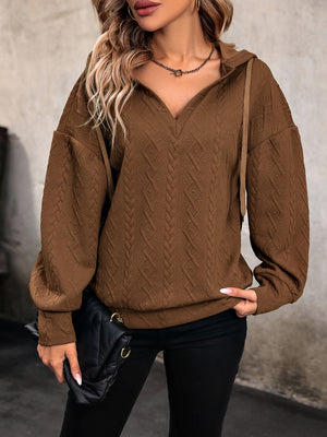 Chestnut cable knit hooded pullover with textured diamond pattern and V-neck.