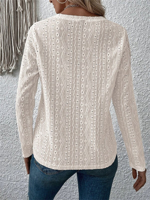 White long sleeve knit top with geometric eyelet pattern and v-neck.