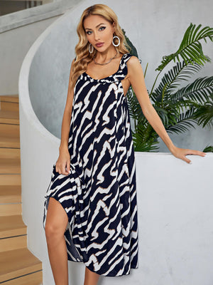 Graphic print midi dress in black and white with ruffled straps and tiered skirt.
