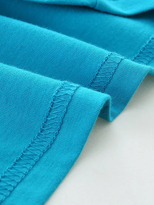Blue cotton t-shirt detail showing double-stitched hem and seams.