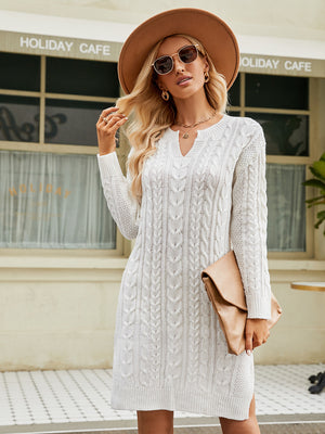 White cable knit sweater dress with keyhole neckline and long sleeves.