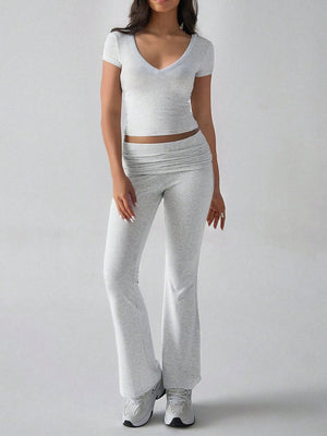Light gray ribbed flare leg lounge set with v-neck crop top and ruched waistband pants.