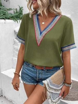 Matcha green v-neck top with embroidered trim on neckline and sleeves
