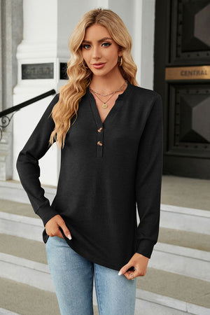 Black waffle knit long sleeve top with button neckline and notched collar.