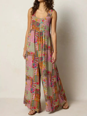 Vibrant patchwork wide-leg romper with a square neckline and wide straps.