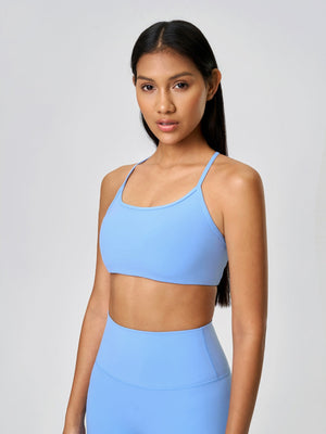 Strappy back active crop top in pastel blue with a square neckline.