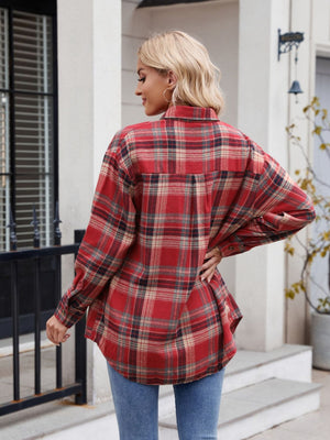 Red plaid overshirt with buttoned cuffs and a curved hem.