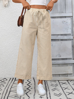 Drawstring wide leg pants in apricot with vertical stripes and pockets.