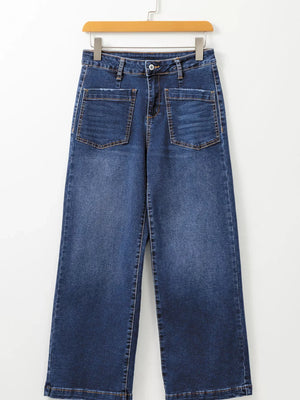 Patch pocket wide-leg jeans in medium wash denim with frayed pocket details.