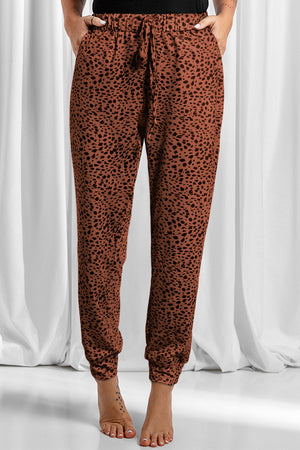 Brown leopard print jogger trousers with drawstring waist and cuffed ankles.
