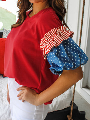 Red maternity t-shirt with ruffled patriotic star print sleeves.